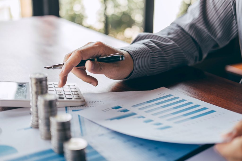 Businessman counting money and making notes at report doing finances and calculate about cost of investment